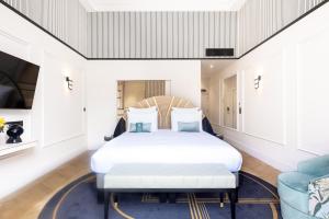 a bedroom with a bed and a couch at The 1932 Hotel & Spa Cap d'Antibes - MGallery Collection in Juan-les-Pins