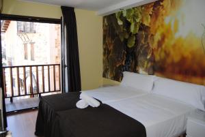 Postel nebo postele na pokoji v ubytování The Way Hotel Molinaseca