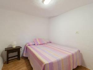 a small bedroom with a bed and a night stand at Casa Valido in Las Palmas de Gran Canaria