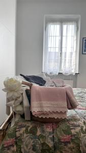 a bedroom with a bed with a blanket and a window at Golfo Paradiso Campane di Uscio piccola bomboniera pochi chilometri Camogli Portofino Santamargherita in Uscio