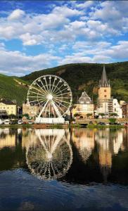 a large ferris wheel sitting on top of a body of water at Ferienwohnung LauterWein in Bernkastel-Kues