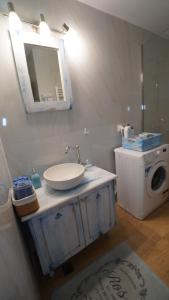 a bathroom with a sink and a washing machine at City Break Metro Ambelokipi in Athens +50 photos