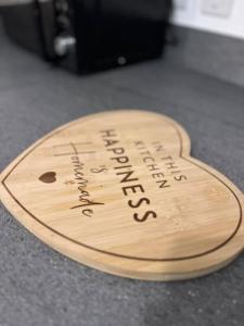 a wooden heart shaped plaque on top of a counter at East London penthouse views 2bd in Barking