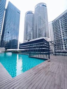 a boardwalk in a city with tall buildings at PROMO Connected Train 2 Bedroom ABOVE MALL 289 in Kuala Lumpur