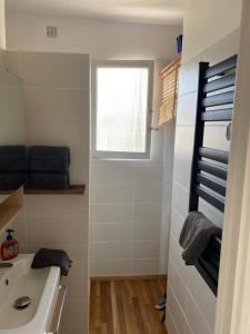 a small bathroom with a sink and a window at Les Lilas in Hyères