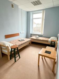 a room with two beds and a window at Apgyvendinimo įstaiga KORNEALITA in Zarasai