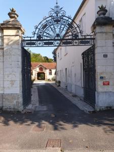 an entrance to a building with an iron gate at Le Vieux Chai in Jonzac