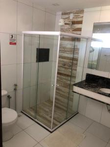 een badkamer met een douche, een toilet en een wastafel bij Casa Aruana in Aracaju