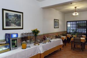 a dining room with a long table in a restaurant at Mira Parque in Albufeira