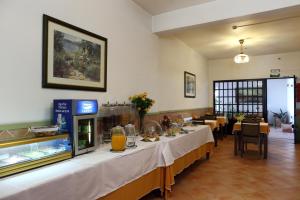 a restaurant with a long table with food on it at Mira Parque in Albufeira