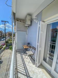 a balcony with a chair and a heater on a building at Alexis apartment near the airport in Corfu