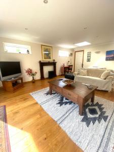 a living room with a couch and a coffee table at Little Dragons in Parkstone