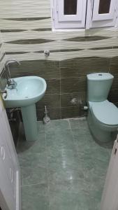 a bathroom with a toilet and a sink at Ikea flat 4 in Hurghada