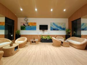 a living room with wicker chairs and a flat screen tv at Pandu Pokhar Eco Adventure Resort in Rājgīr
