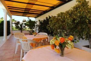 a vase filled with flowers sitting on a table at Mira Parque in Albufeira