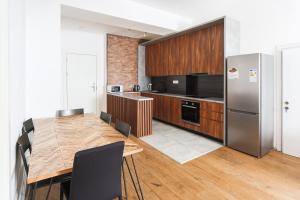a kitchen with a wooden table and a refrigerator at New Gudauri Suites in Gudauri