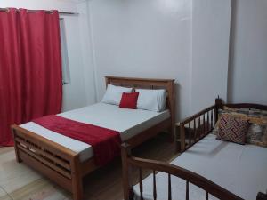 a bedroom with a bed and a red curtain at 2 spacious bedrooms in Mombasa