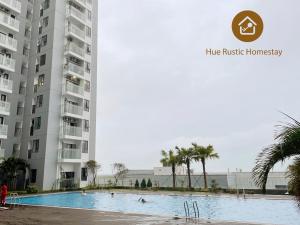 a swimming pool in front of a building at Hue Rustic Homestay with Swimming Pool & Gym Room in Thôn Văn Dương