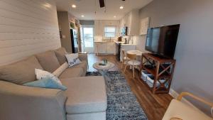 a living room with a couch and a flat screen tv at Bay Tree B3 in Port Aransas