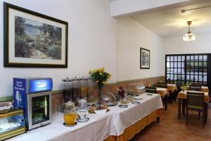 a restaurant with a long table with food on it at Mira Parque in Albufeira