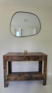 a wooden table with a mirror on a wall at Great location with lake view in Naples