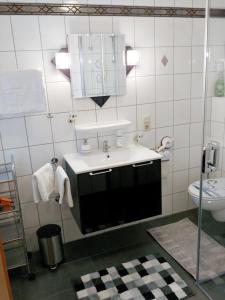 a bathroom with a sink and a toilet at FEWO Traut in Wittlich