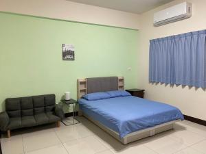 Un pat sau paturi într-o cameră la Qingqing Yi Zhu