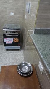a stove in a kitchen with a plate of food at Ikea flat 5 in Hurghada