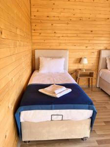 a bedroom with a bed in a wooden room at KARYA TREE HOUSE in Dalaman