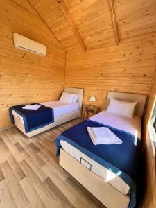 a bedroom with two beds in a wooden cabin at KARYA TREE HOUSE in Dalaman