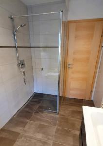 a shower with a glass door in a bathroom at Marie´s Sonnenterrasse 