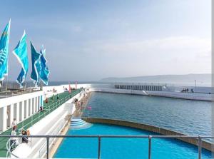 a pool on a cruise ship in the water at Eastern Green Apartment, Penzance - Beach access and Parking in Penzance +24 photos