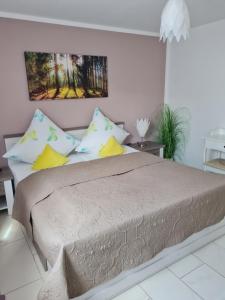 a bedroom with a large bed with colorful pillows at FeWo-Belatona in Rust
