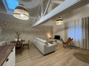 a living room with a white couch and a table at L'escapade in Milly-la-Forêt