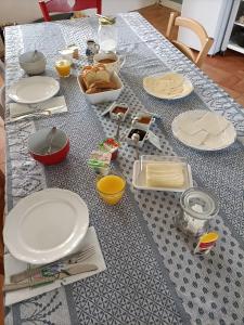 uma mesa com pratos brancos e utensílios em La salamandre de l'escat 