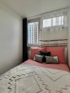 a bedroom with a large bed with a window at Mirovski Apartment in Warsaw