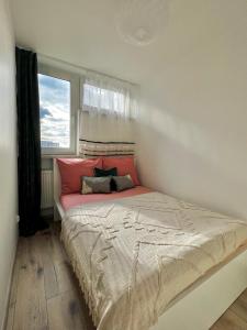 a bedroom with a large bed with a window at Mirovski Apartment in Warsaw