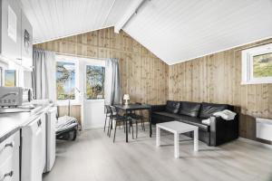 a living room with a couch and a table at Nordica Resort Florø in Florø