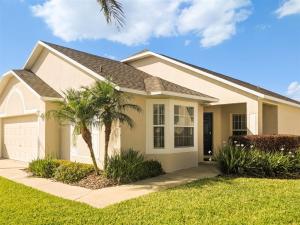 a house with a palm tree in front of it at 4 Bed 428 in Davenport