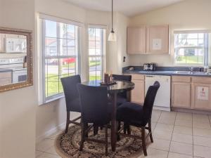 a kitchen with a dining room table and chairs at 4 Bed 428 in Davenport