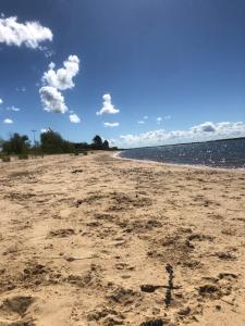 a sandy beach with water and clouds in the sky at Buon riposo! in Concepción del Uruguay