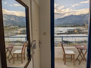 a door leading to a balcony with a view of the mountains at Coral in Frangokastello