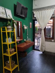 a green room with a desk and a window at InN House Homestay in Dadapan +48 photos