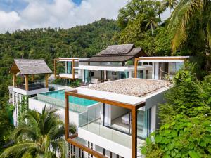 an aerial view of a house with a swimming pool at Samui Privacy Modern Luxury Seaview Natural Rainforest Infinity Pool Villa in Koh Samui 