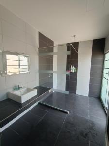 a bathroom with a sink and a bath tub at Pro-Qaseh Room Stay , Darulaman Lake Home in Jitra