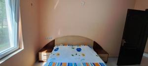 a small bedroom with a bed with a head board at House by the sea in Shekvetili
