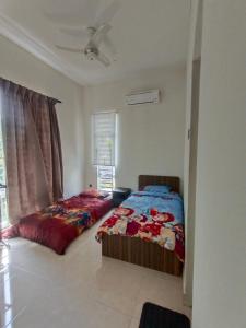 a bedroom with two beds and a window at Pro-Qaseh Room Stay , Darulaman Lake Home in Jitra