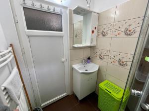 a small bathroom with a sink and a mirror at Garsoniera moderna parcare internet in Piteşti