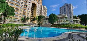 a large swimming pool in front of some buildings at Hilltop Greenview Residence Batu Caves Selayang in Batu Caves