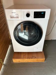 a white washing machine sitting on a wooden shelf at Maroulitsas Sea Esta 1 in Haraki